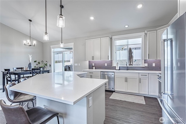 819 N Newport Loop, East Wenatchee, WA 98802 - kitchen with appliances with stainless steel finishes, a kitchen island, a sink, a chandelier, and healthy amount of natural light