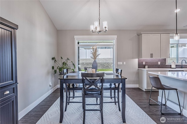 819 N Newport Loop, East Wenatchee, WA 98802 - dining space with baseboards, a chandelier, and dark wood-style floors