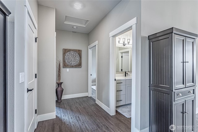 819 N Newport Loop, East Wenatchee, WA 98802 - hallway featuring dark wood finished floors, attic access, baseboards, and a sink