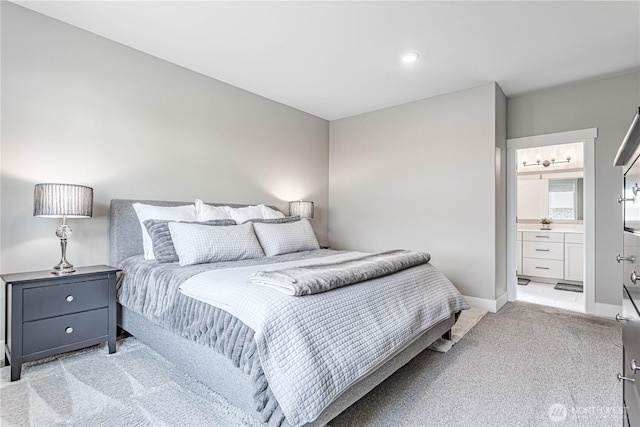 819 N Newport Loop, East Wenatchee, WA 98802 - bedroom featuring light carpet, connected bathroom, and baseboards