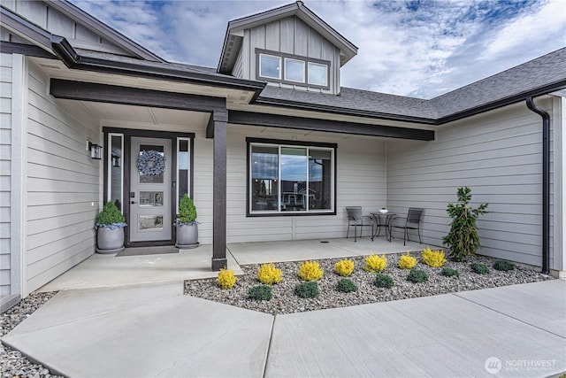 819 N Newport Loop, East Wenatchee, WA 98802 - property entrance featuring a porch, board and batten siding, and roof with shingles
