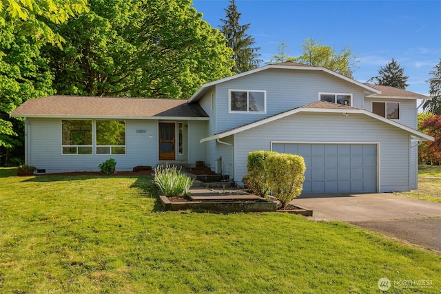 tri-level home with concrete driveway, a front yard, and an attached garage