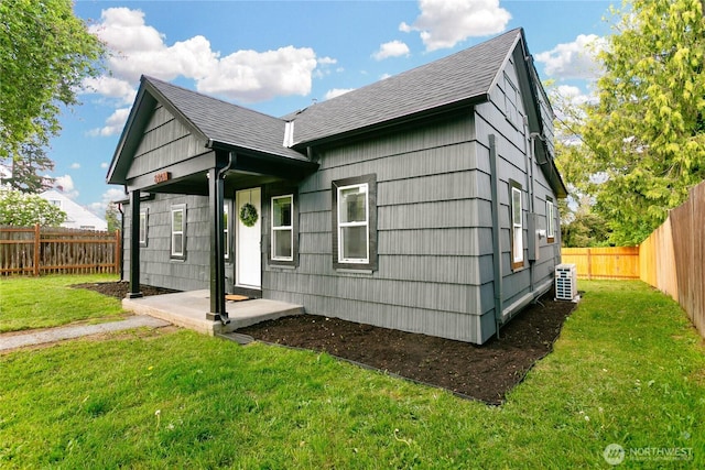 view of front of home featuring cooling unit and roof with shingles