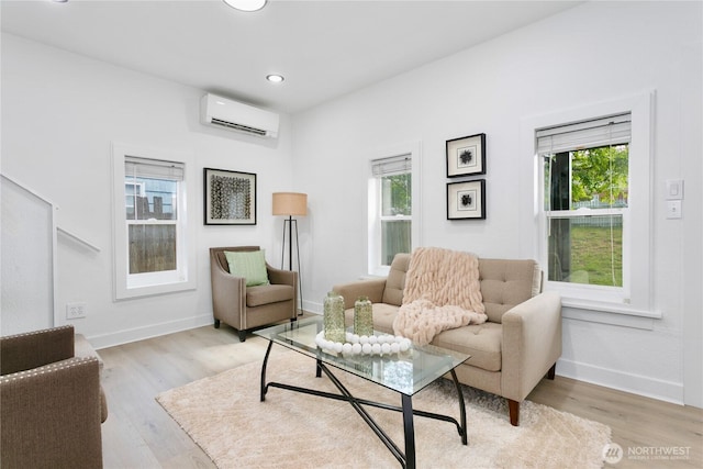 living area with an AC wall unit, wood finished floors, baseboards, and recessed lighting