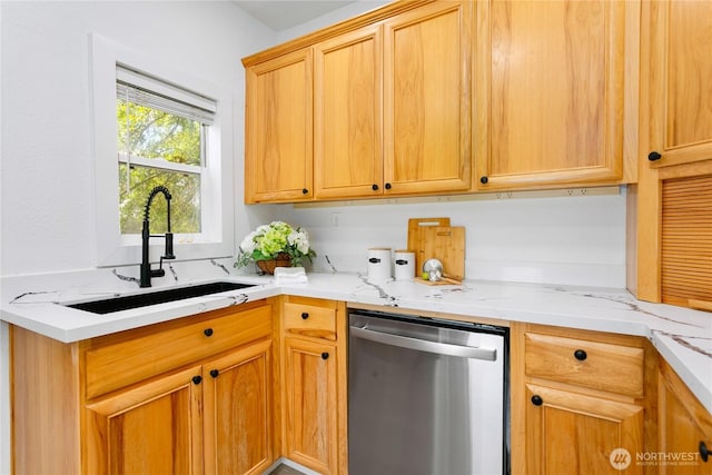 kitchen featuring stainless steel dishwasher, a sink, and light stone counters