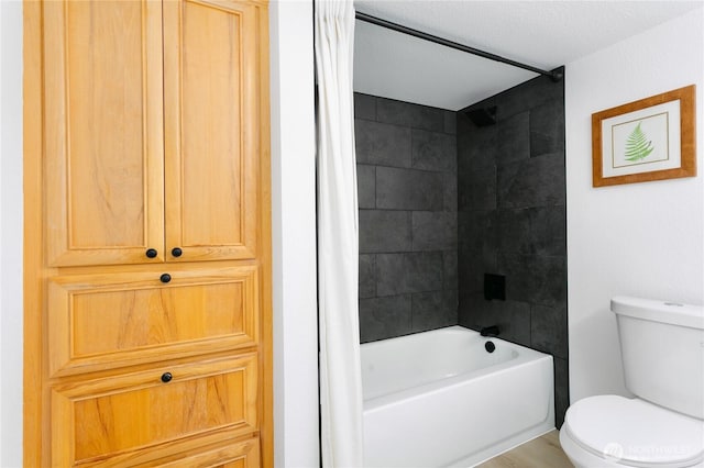 bathroom featuring toilet and shower / bath combination with curtain