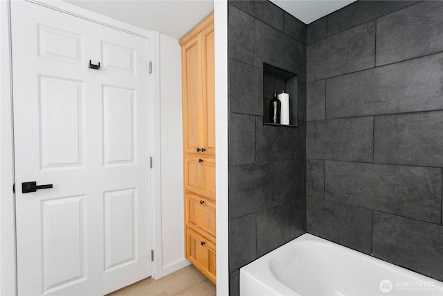 bathroom featuring wood finished floors and baseboards