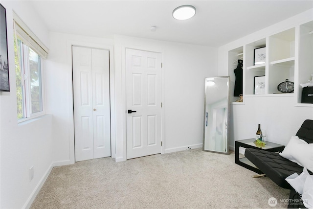sitting room with carpet and baseboards