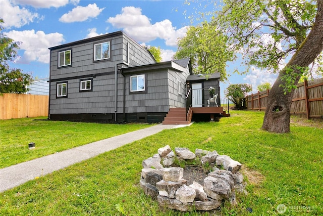 rear view of property featuring crawl space