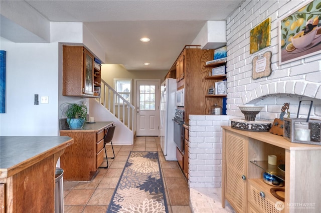 kitchen with brown cabinets, white appliances, open shelves, glass insert cabinets, and recessed lighting