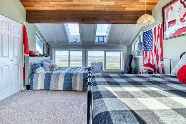 bedroom with carpet flooring and beam ceiling