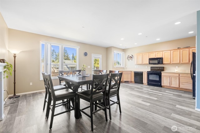 dining room featuring light wood-type flooring, recessed lighting, and baseboards