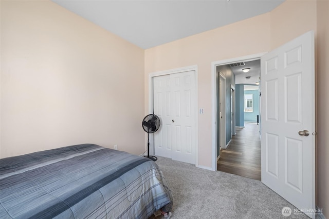 bedroom featuring carpet, a closet, and baseboards