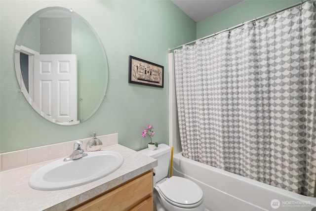 bathroom with toilet, vanity, and shower / bath combination with curtain