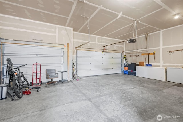 garage with a garage door opener and washer / clothes dryer