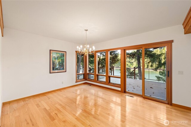 244 Davison Head Dr, Friday Harbor, WA 98250 - unfurnished dining area with a chandelier, baseboards, and light wood finished floors