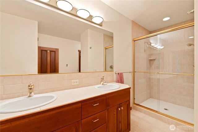 244 Davison Head Dr, Friday Harbor, WA 98250 - full bathroom featuring a shower stall, double vanity, tile patterned flooring, and decorative backsplash