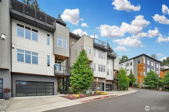 4012 129th Pl SE Unit 2, Bellevue, WA 98006 - view of building exterior with an attached garage and driveway