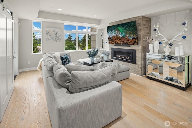 4012 129th Pl SE Unit 2, Bellevue, WA 98006 - living area featuring wood-type flooring, a large fireplace, plenty of natural light, a barn door, and recessed lighting