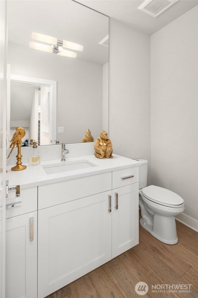 4012 129th Pl SE Unit 2, Bellevue, WA 98006 - bathroom featuring toilet, wood finished floors, and vanity