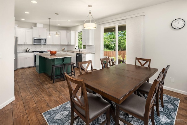 dining area featuring dark wood-type flooring, recessed lighting, and baseboards