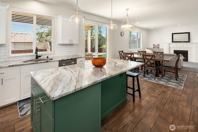 kitchen with a sink, white cabinetry, dark wood-style flooring, tasteful backsplash, and recessed lighting