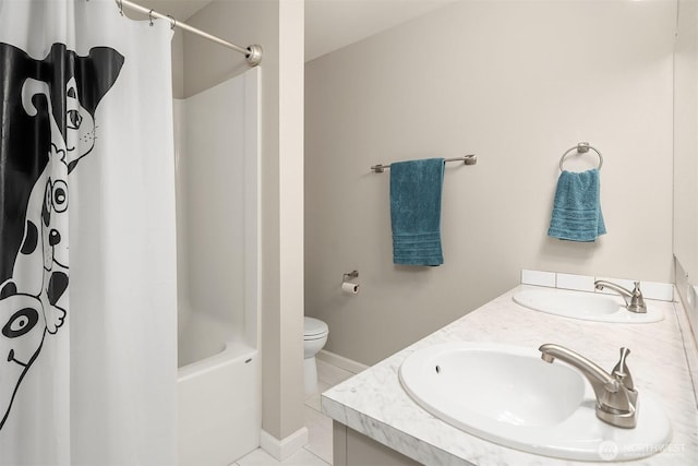 full bathroom featuring double vanity, toilet, shower / bath combo with shower curtain, tile patterned flooring, and baseboards