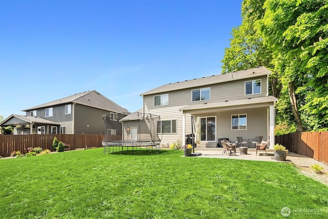 back of property featuring a trampoline, a patio, and entry steps