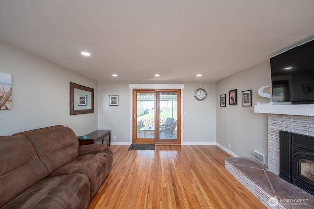 303 Patrick Rd, Ephrata, WA 98823 - living area featuring light wood-type flooring, a stone fireplace, baseboards, and recessed lighting