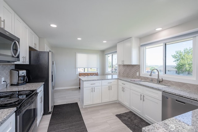303 Patrick Rd, Ephrata, WA 98823 - kitchen with stainless steel appliances, a sink, white cabinetry, light stone countertops, and recessed lighting