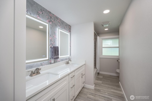 303 Patrick Rd, Ephrata, WA 98823 - full bath with baseboards, toilet, wallpapered walls, double vanity, and shower / bath combo with shower curtain