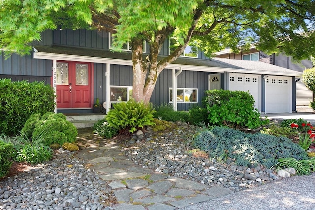 12555 SE 72nd St, Newcastle, WA 98056 - obstructed view of property featuring board and batten siding, a garage, and a shingled roof