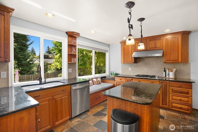 12555 SE 72nd St, Newcastle, WA 98056 - kitchen featuring appliances with stainless steel finishes, under cabinet range hood, a sink, dark stone finish flooring, and backsplash