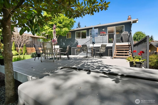12555 SE 72nd St, Newcastle, WA 98056 - rear view of house with outdoor dining area, stairs, a wooden deck, a chimney, and fence