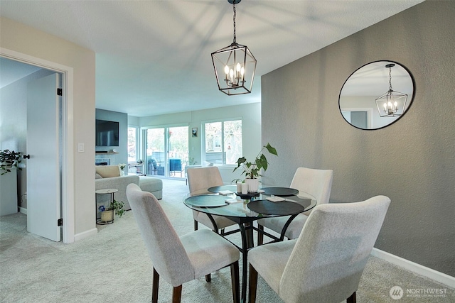 4214 W Lake Sammamish Pkwy NE Unit 202, Redmond, WA 98052 - dining room featuring a chandelier, carpet floors, baseboards, and a textured wall