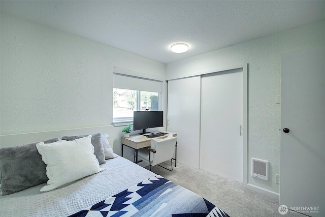 4214 W Lake Sammamish Pkwy NE Unit 202, Redmond, WA 98052 - bedroom featuring a textured wall, carpet, a closet, a textured ceiling, and heating unit
