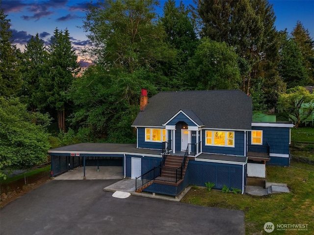 2223 NE 125th St, Seattle, WA 98125 - view of front facade featuring a carport, a chimney, asphalt driveway, and roof with shingles