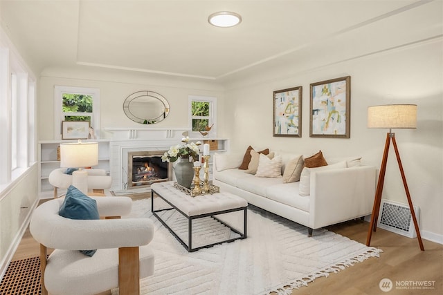 2223 NE 125th St, Seattle, WA 98125 - living room with wood finished floors, baseboards, a glass covered fireplace, and a tray ceiling