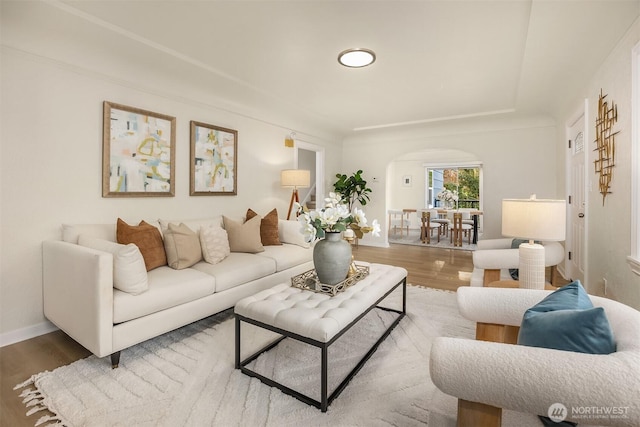 2223 NE 125th St, Seattle, WA 98125 - living room featuring arched walkways, wood finished floors, and baseboards