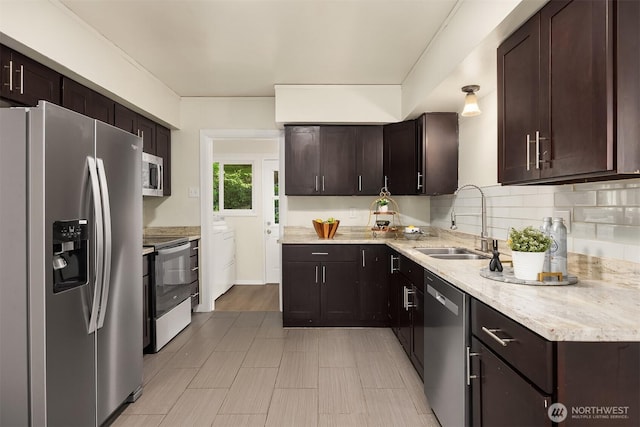 2223 NE 125th St, Seattle, WA 98125 - kitchen with appliances with stainless steel finishes, a sink, independent washer and dryer, and dark brown cabinets