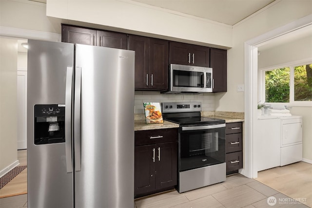 2223 NE 125th St, Seattle, WA 98125 - kitchen featuring washing machine and clothes dryer, stainless steel appliances, dark brown cabinetry, tasteful backsplash, and ornamental molding