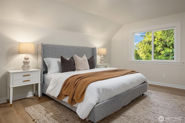 2223 NE 125th St, Seattle, WA 98125 - bedroom with wood finished floors, lofted ceiling, and baseboards