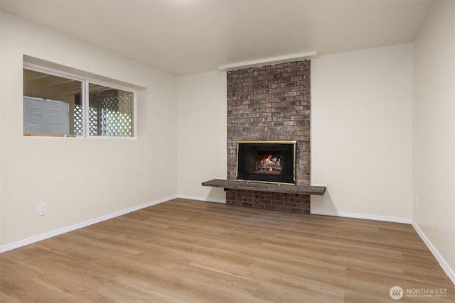 2223 NE 125th St, Seattle, WA 98125 - unfurnished living room featuring wood finished floors, a fireplace, and baseboards