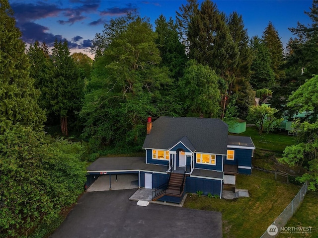 2223 NE 125th St, Seattle, WA 98125 - view of front of home with a chimney, a forest view, and driveway