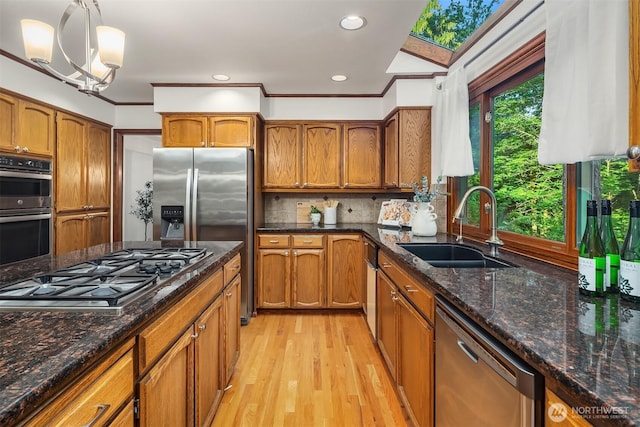 21629 NE 20th Way, Sammamish, WA 98074 - kitchen with stainless steel appliances, a sink, brown cabinetry, recessed lighting, and crown molding