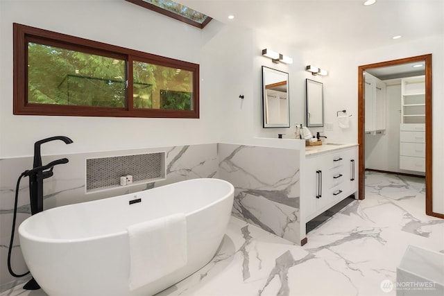 21629 NE 20th Way, Sammamish, WA 98074 - bathroom featuring vanity, a soaking tub, marble tiled floors, a wainscoted wall, and recessed lighting