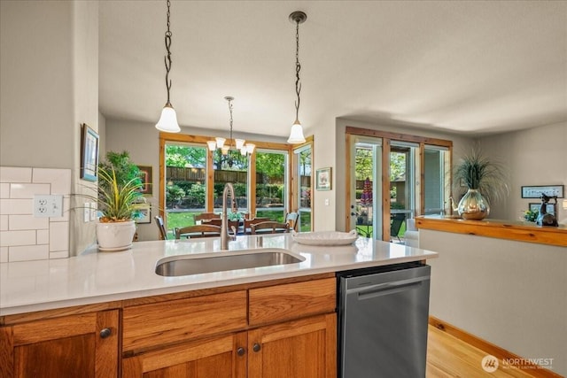 12800 NE Salmon Creek Ave Unit 118, Vancouver, WA 98686 - kitchen featuring stainless steel dishwasher, a sink, healthy amount of natural light, and light wood-style floors