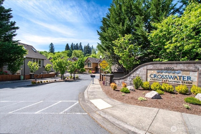 12800 NE Salmon Creek Ave Unit 118, Vancouver, WA 98686 - view of asphalt street with traffic signs, a gate, curbs, sidewalks, and a gated entry