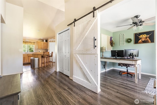 138 Bruinview Ln, Chehalis, WA 98532 - office featuring a barn door, dark wood-style floors, a ceiling fan, and baseboards