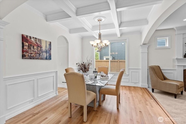 27546 254th Way SE, Maple Valley, WA 98038 - dining room with arched walkways, beamed ceiling, a chandelier, a decorative wall, and plenty of natural light